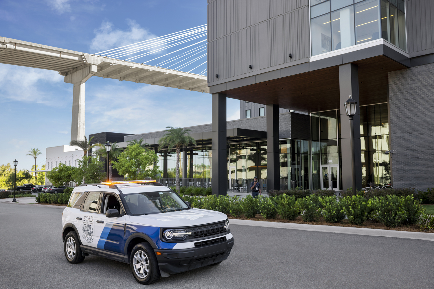 Car, Person, Lamp, Chair, Police Station, Glasses, Office Building, Pickup Truck, Alloy Wheel, Hat