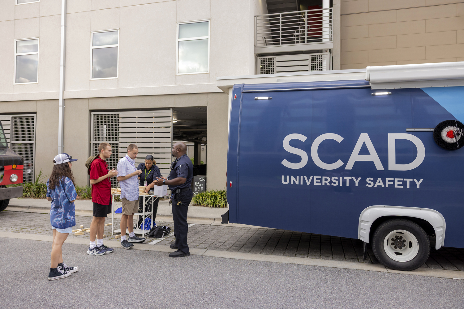 Shorts, Shoe, Person, Car, Hat, Handbag, Advertisement, Wristwatch, Belt, Moving Van