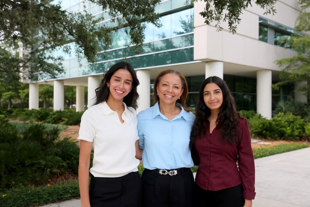 Biomedical sciences students Sarah Gabriela Nieto Chavarro (left) and Juliana Dimetry (right) worked with Georgine Lamvu (center), a UCF College of Medicine volunteer professor of obstetrics and gynecology, to transform years of international research into a practical tool to help clinicians evaluate patients more quickly and confidently. (Photo by Eddy Duryea ’13)