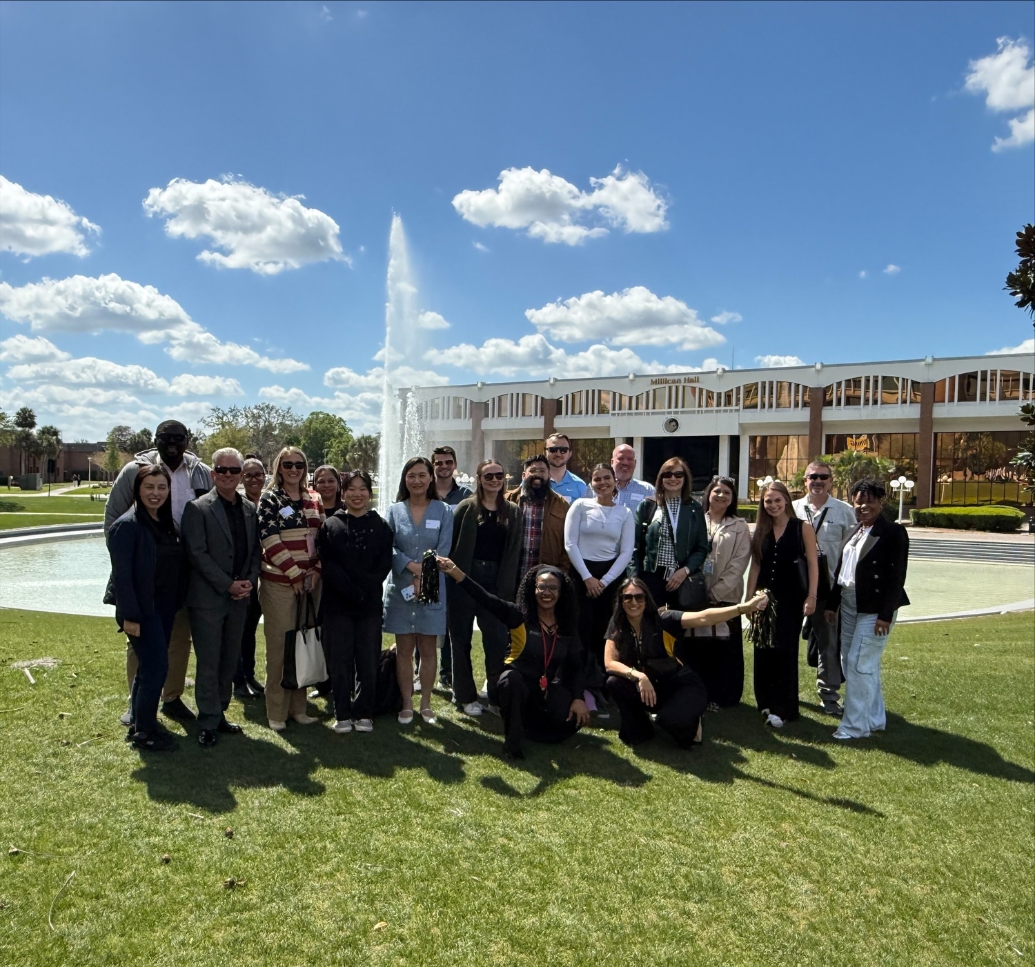 New employees posing in front of the Reflecting Pond during the NEO bus tour.