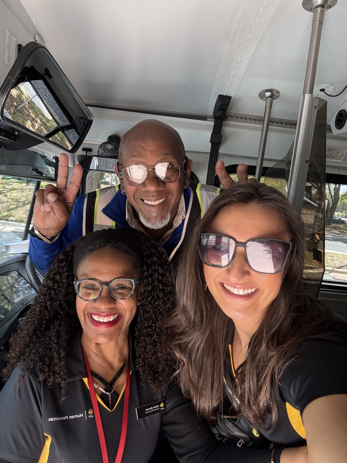 Zakia and Sally posing with the driver on the NEO bus tour.