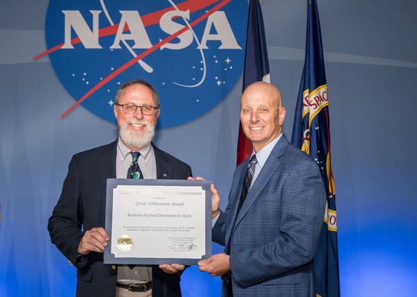 Adult, Male, Man, Person, Suit, People, Crowd, Flag, Face, Text