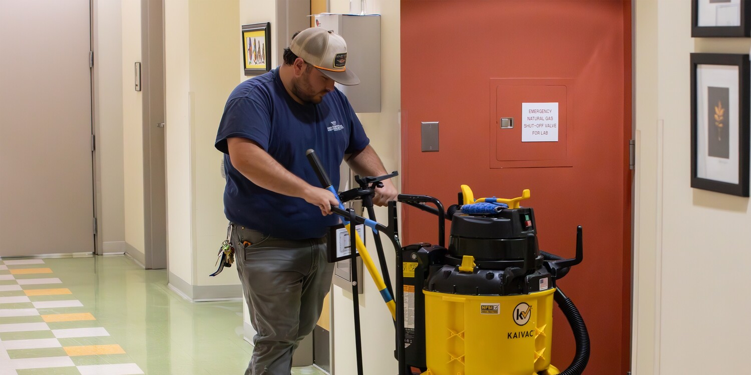 Custodial employee cleaning floors