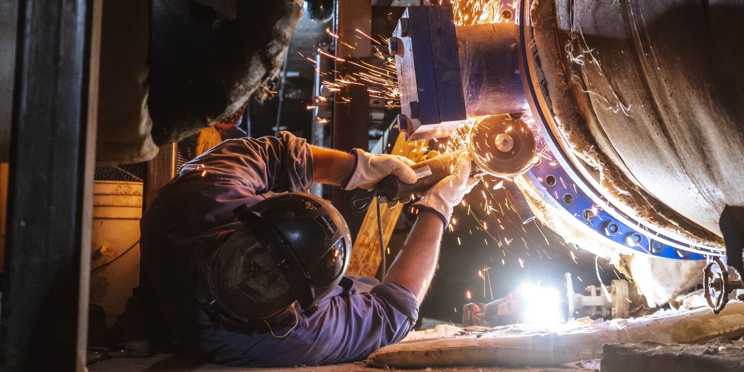 Sparks fly while an employee works on the Steam Tunnel