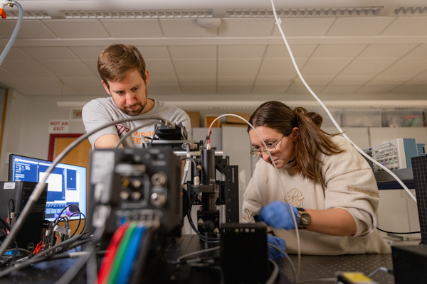 A man and a woman working in a lab