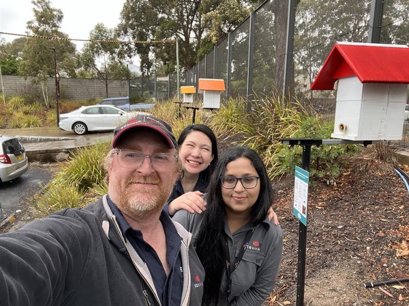 Matt and fellow Equinix employees beside the beehives located around Equinix Data Centers