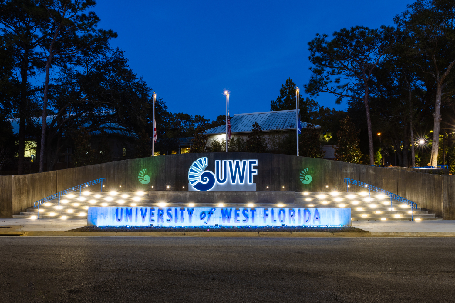 Picture of the new UWF sign at night as you enter campus