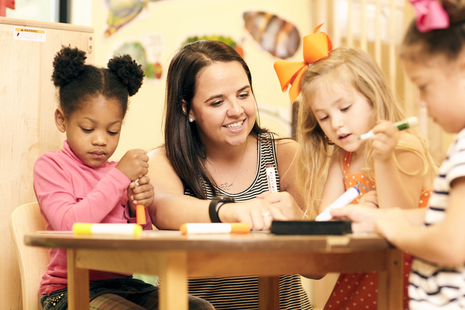 Picture of teacher and kids at the childcare center