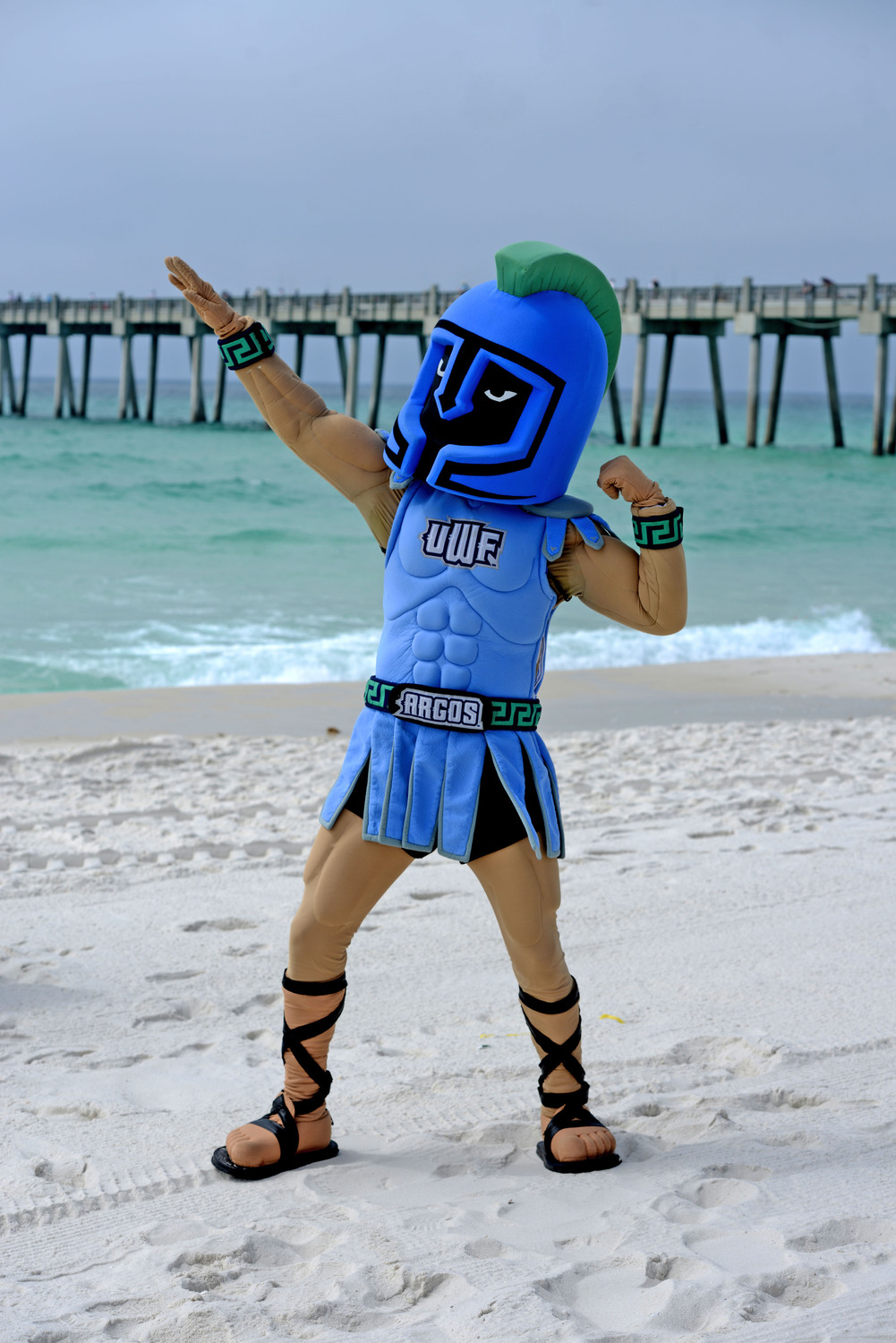 Argie mascot on the beach posing
