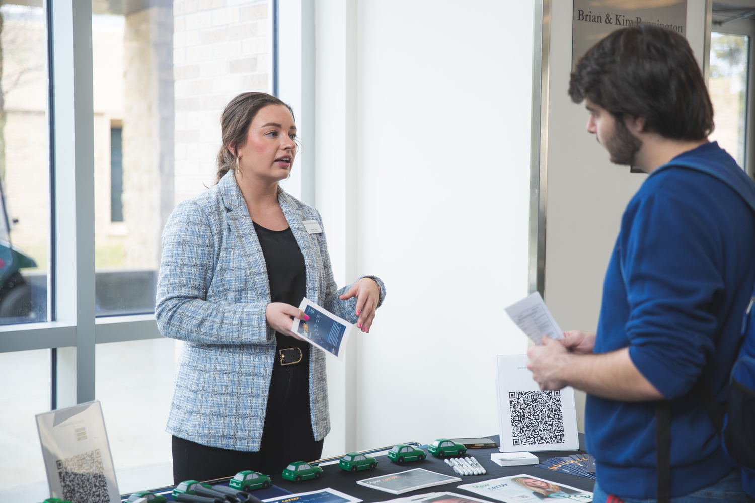 Employee at a job fair talking to a candidate