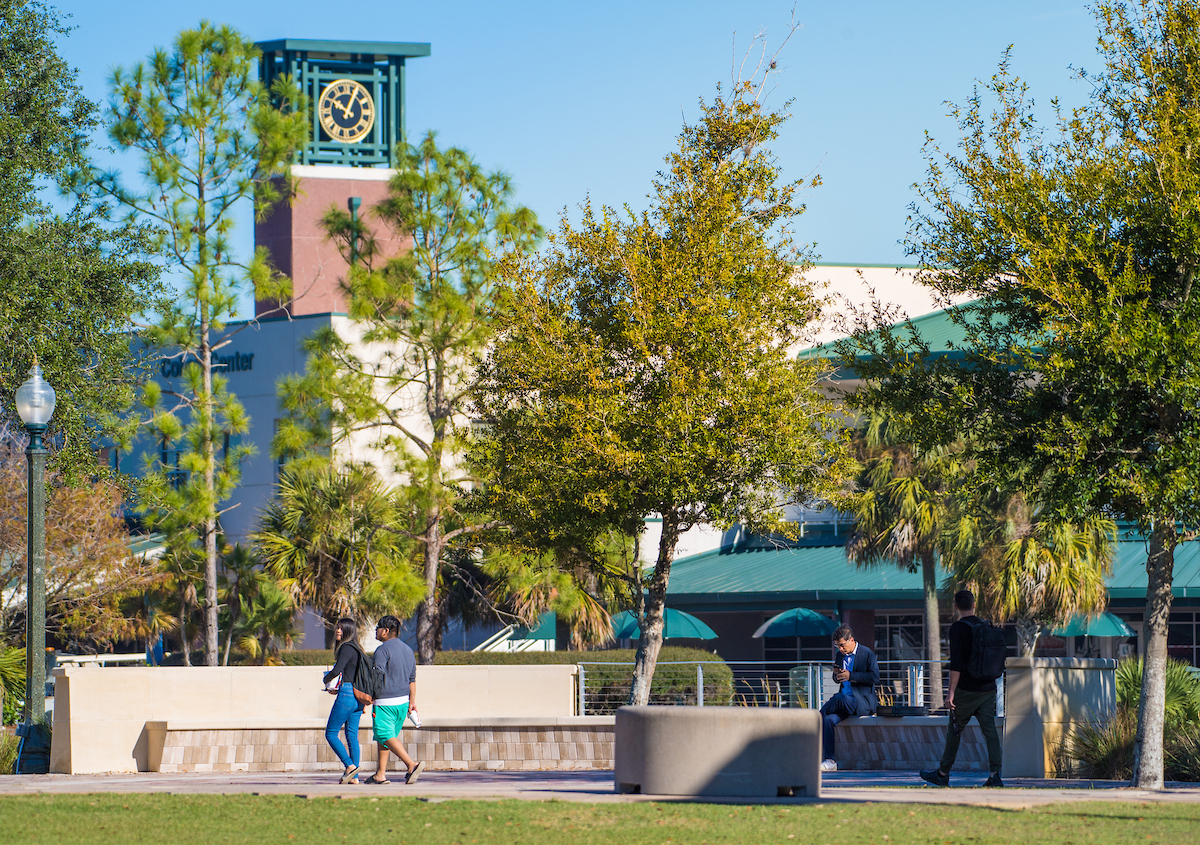 Clock Tower, Tower, Clothing, Shorts, Person, Walking, Tree, Jeans, Campus, Shoe