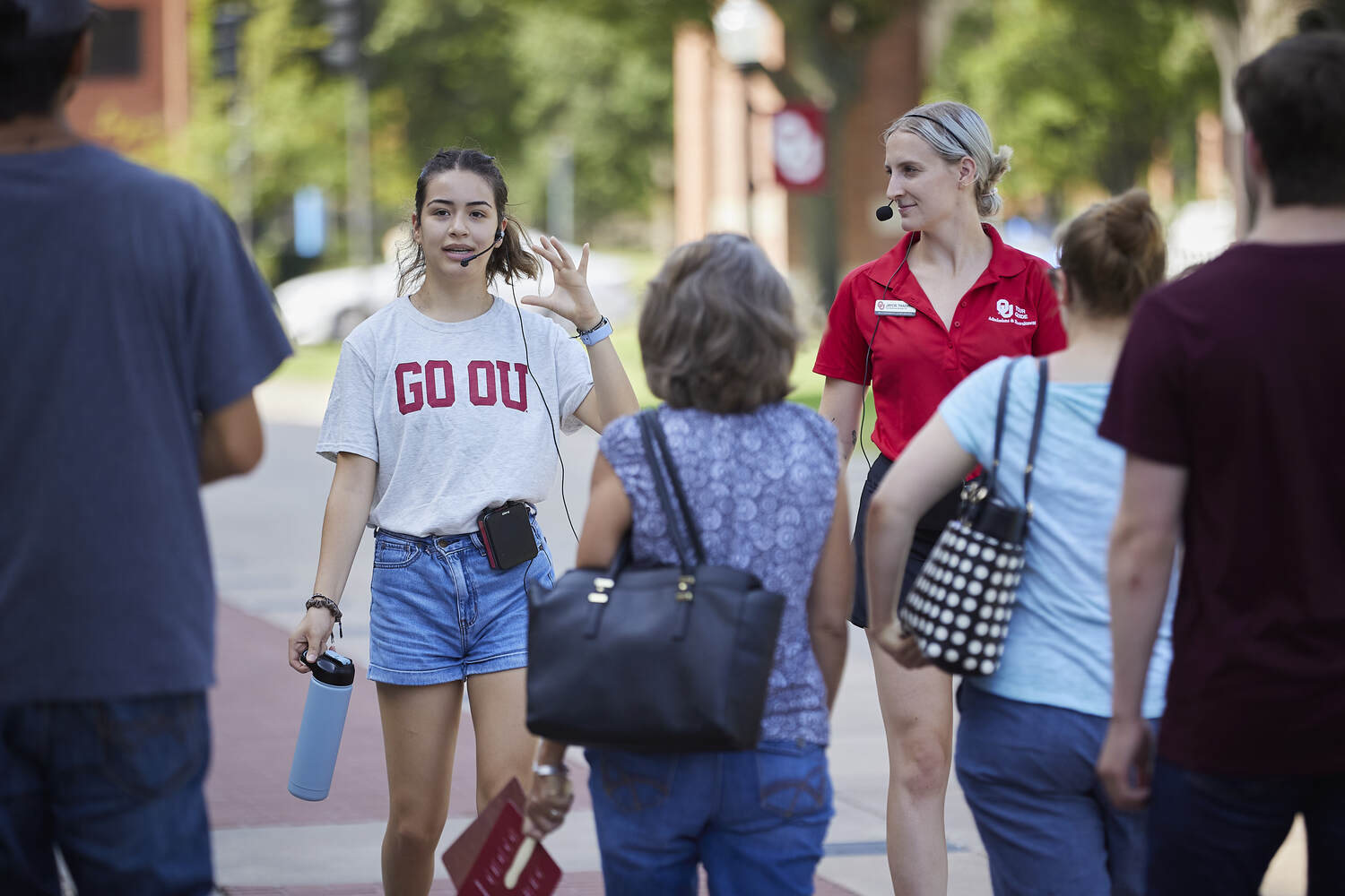 People walking on a campus path with the word “STUDENT” across the image.